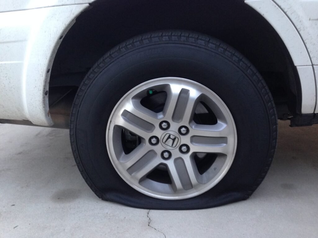 Close-up of a deflated car tyre