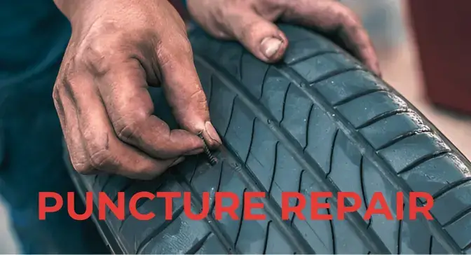 Tyre technician inspecting suspected puncture damage