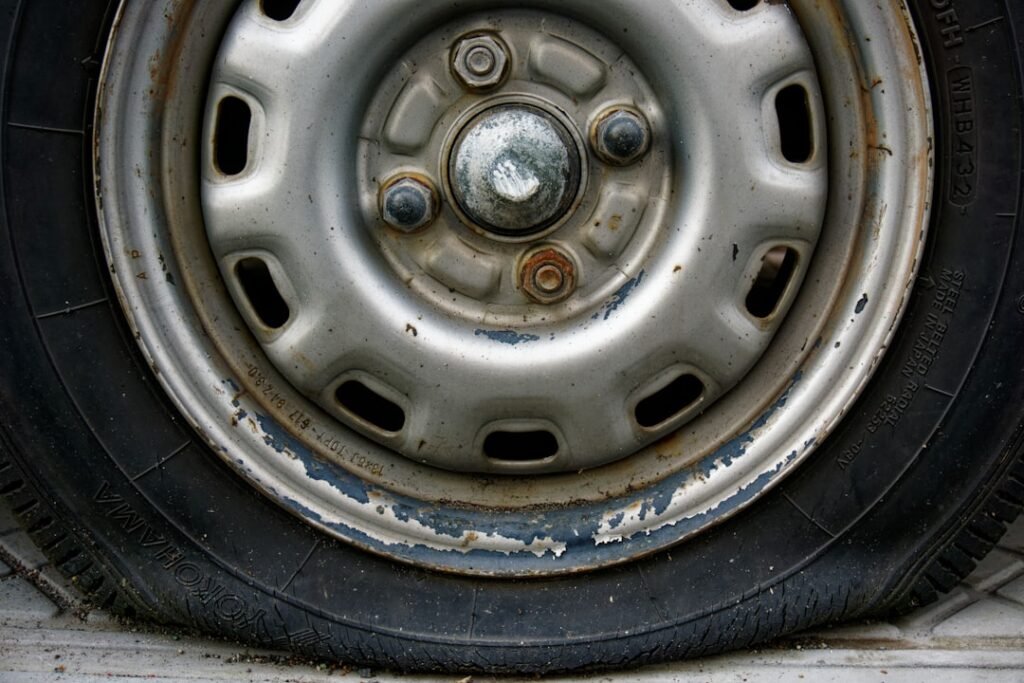 Close-up of a worn vehicle tyre and wheel